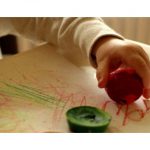 Example of child using wide crayons made from multiple smaller crayons