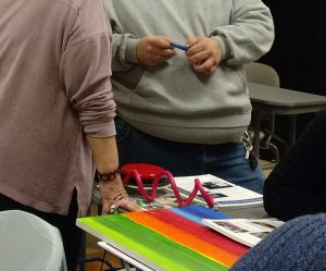 Volunteers discuss materials for a project.