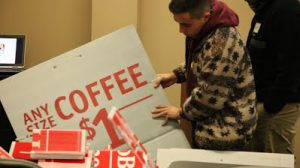 Volunteer sorts through items for a project.