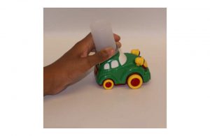 Toy car with old film canister attached for easy gripping