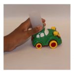 Toy car with old film canister attached for easy gripping