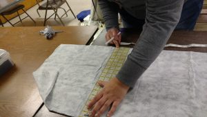 Measuring fabrics for constructing a garment protector.