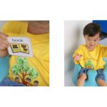 Child with photo symbol card.