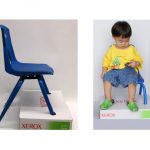 A cardboard box allows a child's feet to touch the floor.